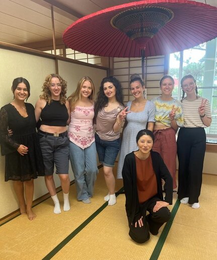 Gruppenbild unter einem großen Schirm.