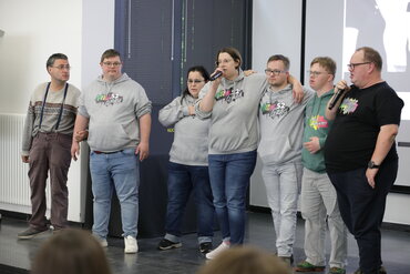 Die sieben Bandmitglieder stehen gemeinsam auf der Bühne