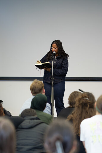 Eine Frau steht auf der Bühne und performt.