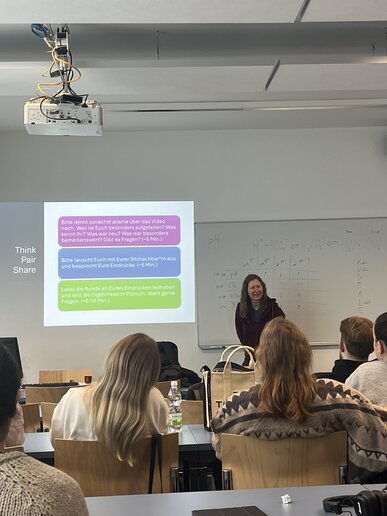 Frau Schäfer-Wiesen hält eine Vorlesung in vollem Hörsaal.