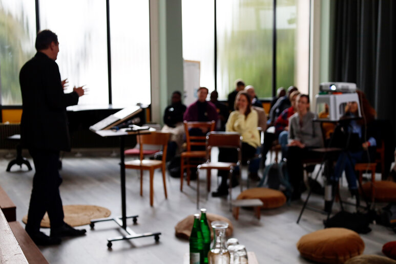 Einblick in eine Veranstaltung der Tagung mit Redner und Zuhörenden.