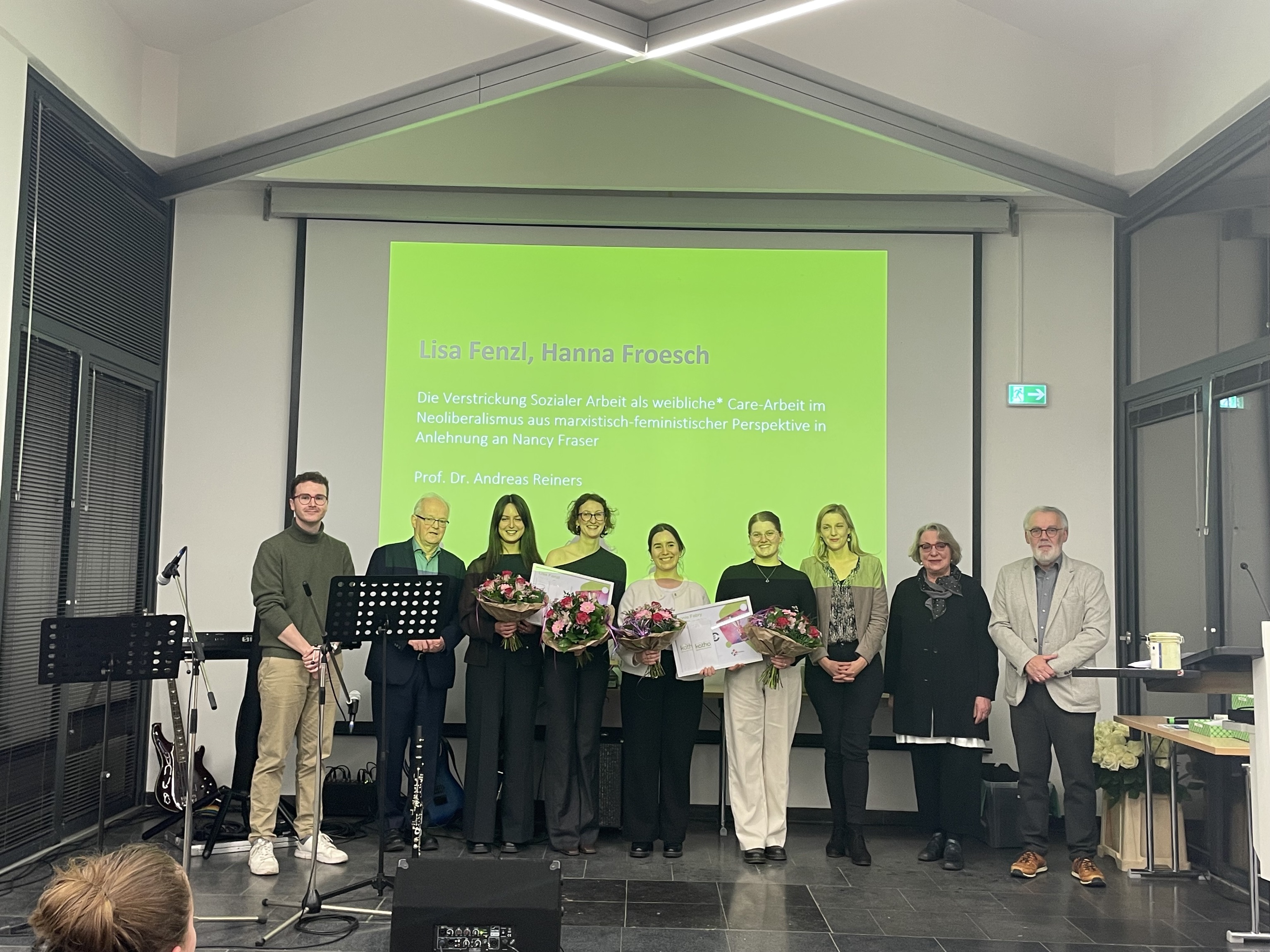 Die Preisträgerinnen halten Blumen in der Hand, links und recht von ihnen stehen die Jurymitglieder, alle stehen auf der Bühne aufgereiht zum Gruppenfoto