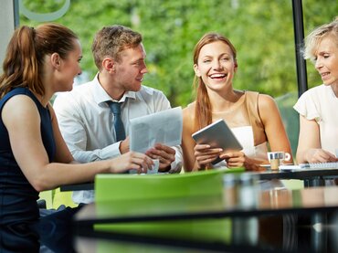 Geschäftsfrau lacht im Meeting mit dem Team